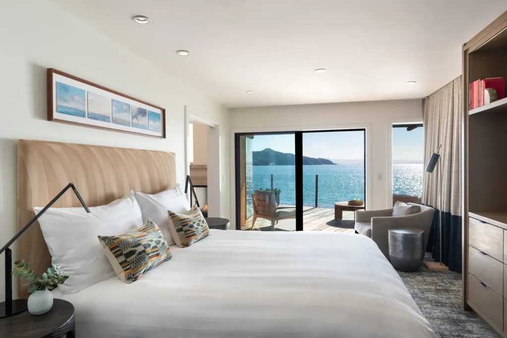 Guest suite at this Sausalito hotel with king bed and doors to a private deck over the bay